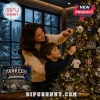New York Yankees 24-Day Christmas Advent Calendar box next to a woman and boy hanging team-themed ornaments on a tree.