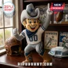 NFL Dallas Cowboys mascot soft plush toy wearing a grey uniform, blue bandana, and cowboy boots on a wooden desk.