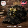 Nirvana Nevermind Smiley Camouflage Baseball Cap with yellow embroidered logo on a dark green and brown camo cotton fabric.