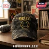 Nirvana Nevermind Smiley Camouflage Baseball Cap with yellow logo embroidery on a dark green woodland camo fabric base.
