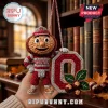 Ohio State Buckeyes Brutus Mascot Crocheted Car Ornament hanging against a background of vintage library bookshelves.