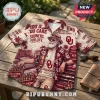 Oklahoma Sooners NCAA Maroon Hawaiian shirt featuring palm trees, vintage sports graphics, and team text on a wooden table.