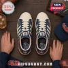 Ole Miss Rebels Adidas Casual Sneakers featuring white soles, navy blue accents, and mascot graphics on a wood surface.