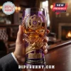 Omega Psi Phi 115th Anniversary purple beer glass featuring gold fraternity crest and 1911-2026 dates held in a hand.