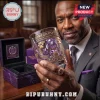 Omega Psi Phi Bulldog Engraved Whiskey Glass with purple emblem held by a man wearing a matching fraternity ring.