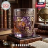 Omega Psi Phi Bulldog Engraved Whiskey Glass with purple tint, gold detailing, and Greek letters on a wooden coaster.