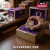 Omega Psi Phi Gold Tone Purple Watch featuring Greek letters on a textured dial inside a matching custom presentation box.
