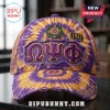 Omega Psi Phi Purple and Gold Custom Baseball Cap featuring tie-dye fabric, distressed detailing, and fraternity insignia.