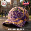 Omega Psi Phi Purple and Gold Custom Baseball Cap with distressed fabric, Greek letters, and 1911 embroidery on a table.