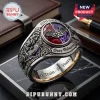 Ozzy Osbourne 1970-2026 Engraved Ring with red and purple stone, silver bat details, and etched text on a marble base.