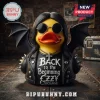 Ozzy Osbourne Bat Wings Rubber Duck Statue wearing black leather jacket, sunglasses, and silver cross on a brick background.
