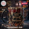 Ozzy Osbourne Prince of Darkness coffee mug with 3D skulls, bat wings, and a matching bat-shaped spoon on a wooden table.