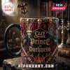 Ozzy Osbourne Prince of Darkness coffee mug with gold skull and bat detailing, flame motifs, and a matching metal spoon.