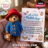 Paddington Bear needle felted pocket hug wearing a red hat and blue coat, held next to an encouraging poem card.
