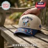 Peanuts Autism Awareness Snoopy Beige Baseball Cap featuring Snoopy and Woodstock with a puzzle piece pattern on a bench.