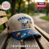 Peanuts Autism Awareness Snoopy Beige Baseball Cap featuring Snoopy, Woodstock, and colorful puzzle piece embroidery.