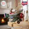 Peanuts Snoopy Flying Ace Christmas Tree Ornament featuring Snoopy in a pilot cap on a green vintage biplane.