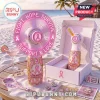 Pink Ribbon LED Rechargeable Hand Fan with floral gold base and inspirational text on a beach table background.