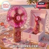 Pink Ribbon LED rechargeable hand fan featuring Fight Hope Survive text, displayed on a wooden beach table with accessories.