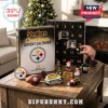 Pittsburgh Steelers Christmas Advent Calendar with 24 Ornaments featuring team-branded figurines on a wooden table.