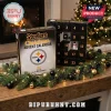 Pittsburgh Steelers Christmas Advent Calendar with 24 ornaments features team logos on black boxes near a fireplace.