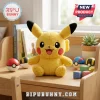 Pokemon Pikachu Soft Plush Toy with yellow fur, black-tipped ears, and red cheeks sitting on a wooden desk near toys.