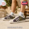 Rat Fink x Adidas Purple Casual Shoes featuring Ed Roth character art, white stripes, and cream suede panels on feet.