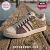 Rat Fink x Adidas Purple Casual Shoes featuring green monster graphic, white leather details, and flame motifs on a dock.