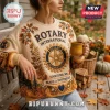 Rotary International Service Above Self beige ugly sweater featuring a central gear logo, autumn leaves, and text details.