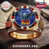 Rush Rock Band Gemstone Ring featuring a blue center stone, owl motif, red square gems, and gold band on a wooden table.
