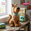 Scooby Doo Brown Plush Toy sits on a wooden shelf next to Mystery Machine vans and vintage comic books.