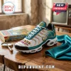 Scooby Doo Mystery Machine Teal Air Max Plus Sneakers featuring gold accents, white mesh, and graphic branding on a desk.