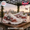 Skechers Kansas City Chiefs D'Lites chunky sneakers with mascot graphic, text, and stadium details on a wooden table.