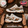 Skechers Texas Longhorns Mascot White Walking Sneakers featuring orange university branding and stadium graphics on wood.