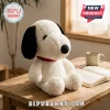 Snoopy Sherpa Fabric Character Plush Pillow featuring white textured material, black ears, and a red collar on a table.