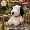Snoopy Sherpa Fabric Character Plush Pillow featuring white faux fur texture, black ears, and a red collar on a bench.