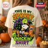 Snoopy x Pringles Halloween Spooky Snackin T-Shirt in cream featuring Snoopy in a witch hat with Pringles and a haunted house.
