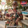 South Sydney Rabbitohs NRL Hawaiian shirt featuring team logos, tropical prints, and beer graphics on a man at a resort bar.