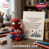 Spider-Man Handmade Felt Pocket Hug holding a white web token next to a card featuring a city skyline and uplifting text.