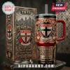 St Kilda Saints YETI Stanley Tumbler with red, black, and gold team emblems and matching collector box on a marble base.