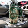 Starbucks 55th Anniversary YETI Stanley Tumbler with green tie-dye pattern, logo, and coffee graphics in a car cup holder.
