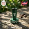 Starbucks Monopoly Collector Edition Board Game green plastic tumbler with straw on a stone surface with coffee beans.