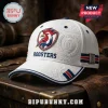 Sydney Roosters Embossed Logo White Cap with a red, blue, and white crest featuring rugby motifs on a textured white fabric.
