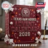Texas A&M Aggies 150th Anniversary Advent Calendar 2026 in maroon with white ribbons, snowflake patterns, and fairy lights.