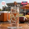 Texas Longhorns 40oz Rhinestone Tumbler with Handle featuring team mascots, logos, and orange gems at a football stadium.