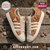 Texas Longhorns Burnt Orange Leather Sneakers with white stripes and team graphics on a rustic wooden background.