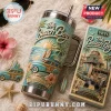 The Beach Boys 40oz YETI Tumbler With Handle featuring a coastal surf van design, palm trees, and metallic lid.