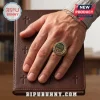 The Chosen 7th Anniversary Crystal Ring on a hand resting over a brown leather book with cross imprints.