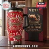 The Dolphins Rugby League 3rd Anniversary YETI Tumbler with red tie-dye pattern, gold logo, and stadium graphic on table.