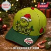 The Grinch Merry Grinchmas 2026 Holiday Cap in lime green with embroidered character, red brim, and holly accents.